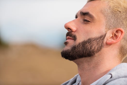 Side view of young handsome bearded man. photo