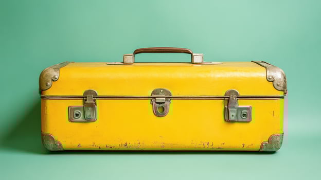 A Vibrant Yellow Suitcase Perfect for Travel Adventures on a Light Green Background photo
