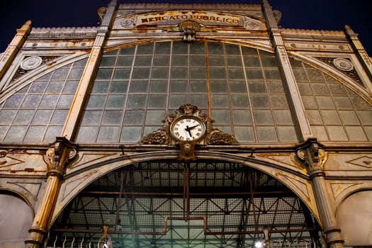 Old clock hanging on ancient market wall. photo