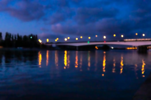 Blurred Nagatinsky metro bridge with moving train over Moscow river at night. Copy space for text. photo