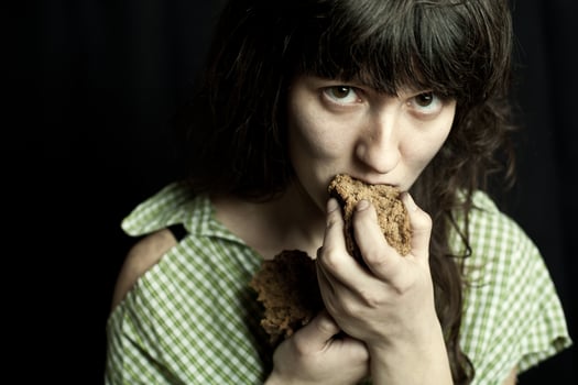 beggar woman eating bread photo
