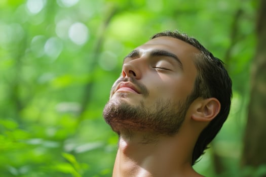 A man relaxes in a green forest while practicing mindfulness and enjoying nature on a peaceful day photo