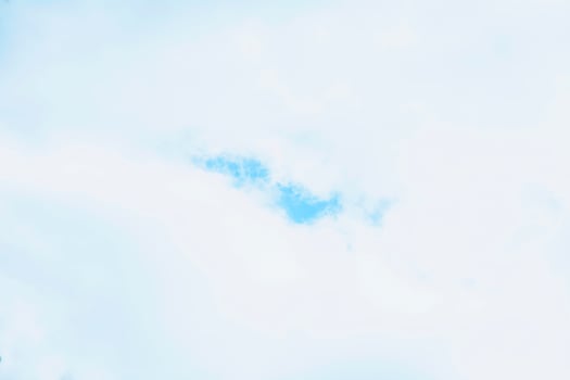 A plane flying in the sky with a blue sky photo