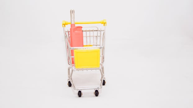 A toy shopping cart with a yellow umbrella photo
