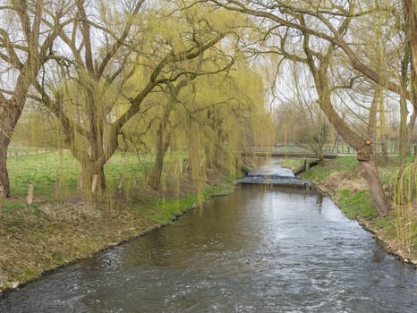 A river running through a field in westphalia photo