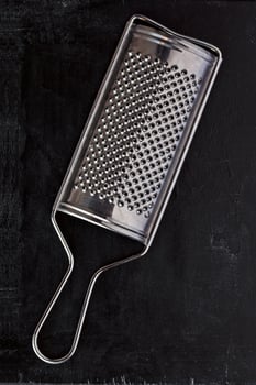 metal grater on black photo