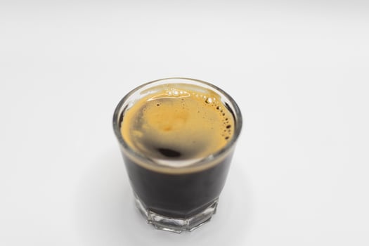Black Espresso Shot in a Glass on White Background. photo