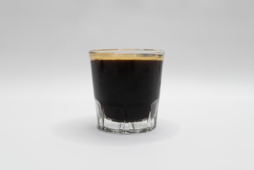 Black Espresso in Glass on Clean White Background. photo
