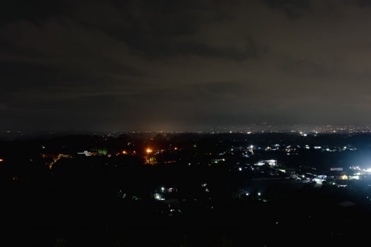 City Skyline at Night Under Clouds photo
