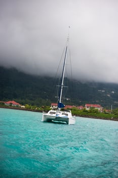 Recreational Yacht in fog at the coast of Seychelles photo