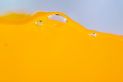 Close up bright orange juice splash texture for health and nature waves, Beautiful waves curve and little bubbles smooth for garphic design and background photo