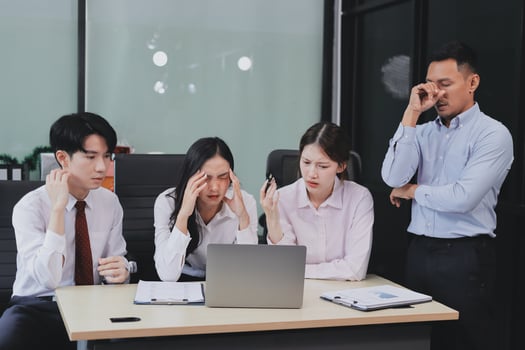 Frustrated upset multiracial business team people sad with bad work result in report disappointed in corporate bankruptcy failure crisis worried of paperwork problem sit at table at office meeting photo