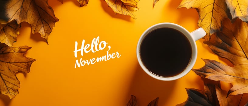 A warm and cozy scene that features a steaming cup of coffee carefully placed on a saucer, beautifully surrounded by vibrant and colorful autumn leaves, celebrating the delightful arrival of November photo