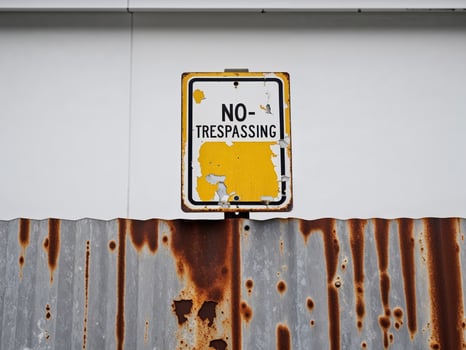 A rusty sign on a wall photo