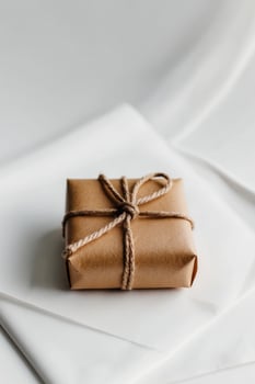 A brown wrapped gift on a white background photo