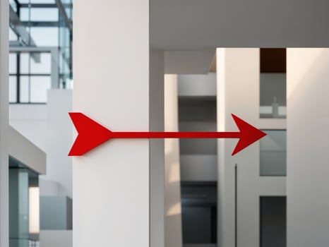 A red arrow pointing to the right in a building photo