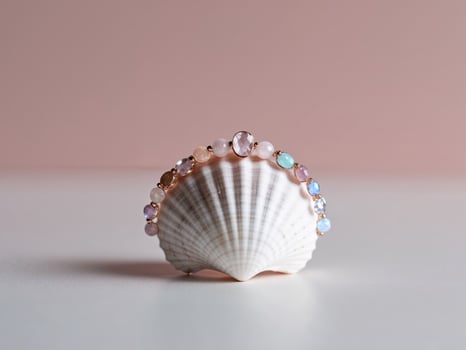 A shell with pink and blue beads on it photo