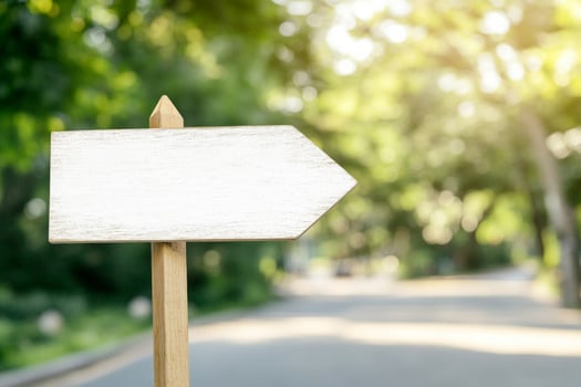 Minimalist outdoor signage mockup with blank white rectangular sign on a city street in soft daylight photo