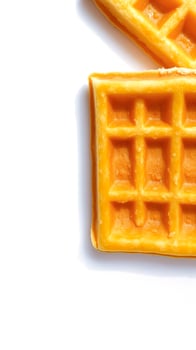 two golden waffles on a white surface photo