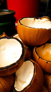 pile halved wooden bowls with white interiors black rims photo