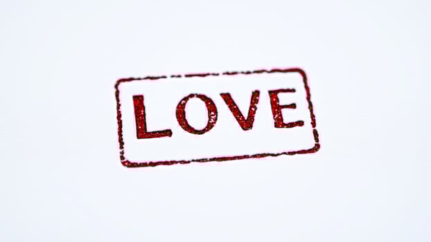 glittery red rubber stamp imprint the word love photo