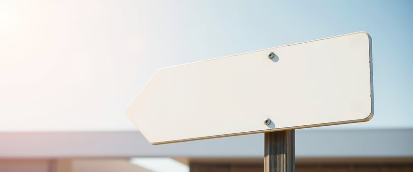 blank white arrow sign mounted on a metal post photo