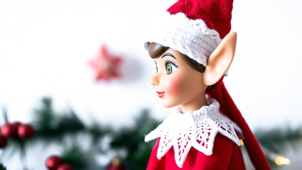 festive elf doll with a red knitted hat white lace collar. photo
