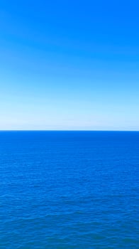 calm blue ocean under a clear sky photo