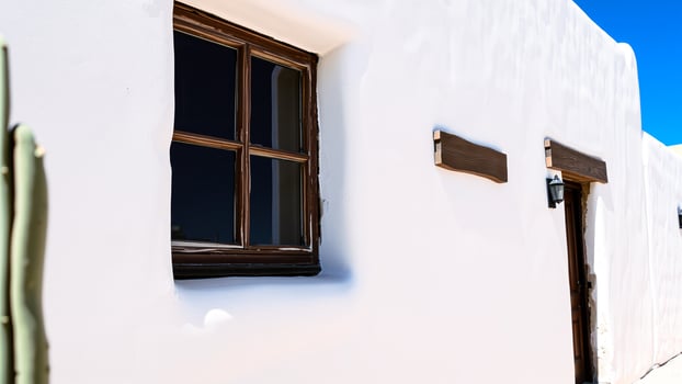 white stucco building with a wooden door window photo