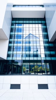 modern building with a glass facade reflecting the cityscape photo