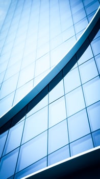 modern building's glass facade with a curved ledge photo