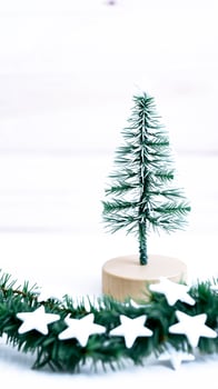 miniature snowy evergreen tree with star ornaments photo