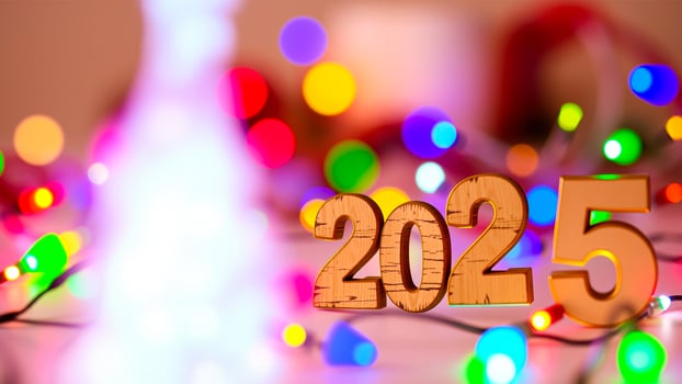 wooden 2025 sign stands amidst a blurred background festive lights photo