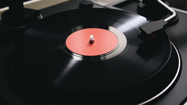 spinning black vinyl record with a red label photo