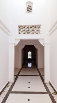 white hallway with an ornate window patterned tile floor photo
