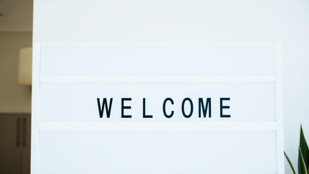 white welcome sign with black letters photo