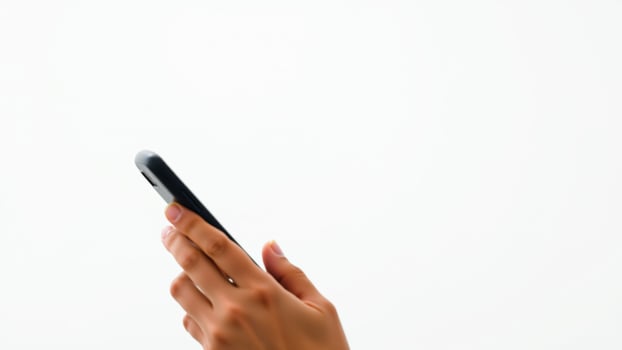 hand holding a black mobile phone against a white background photo