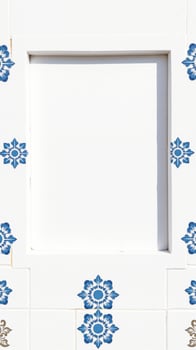 white tile wall with blue white floral designs photo