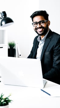 smiling man a suit at a desk photo