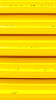 close- a yellow metal surface with horizontal ridges photo