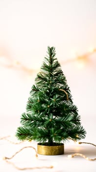 small artificial tree with golden lights photo