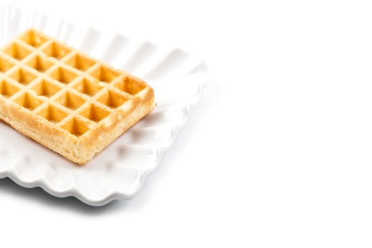 Belgium waffer on white ceramic plate isolated on white background. photo