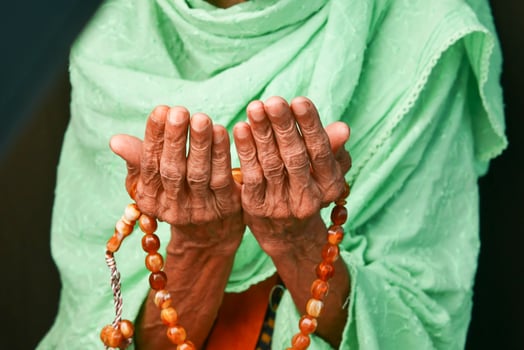 Close up of senior women hand praying at ramadan photo