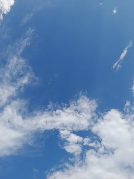 Beautiful white clouds on deep blue sky background. Large bright soft fluffy clouds are cover the entire blue sky. photo