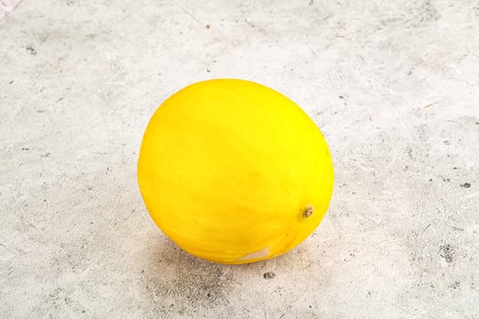 Sweet juicy whole yellow melon photo