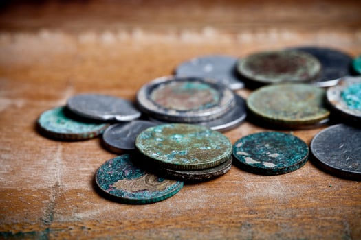 Pile of different ancient copper coins with patina. photo