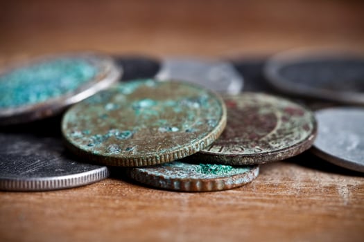 Pile of different ancient copper coins with patina. photo
