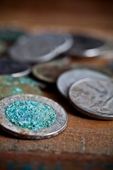 Pile of different ancient copper coins ccloseup on rustic wooden table background. photo