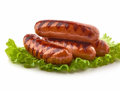 whole grilled sausages with herbs and spices. isolated on white background photo