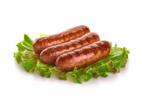 whole grilled sausages with herbs and spices. isolated on white background photo